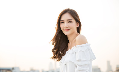 Portrait of young beautiful innocence asian woman in sky roof top. Smile face asian girl wear...