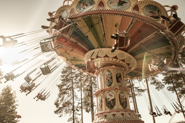 Fototapeta na wymiar Kouvola, Finland - 18 May 2019: Ride Swing Carousel in motion in amusement park Tykkimaki