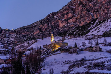 winter landscape (at sunset) of the high Valtellina, between the Italian central Alps, village of...