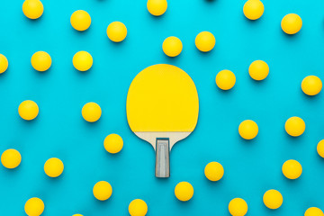 racket and many balls for table tennis on turquoise blue background. flat lay image of many table...