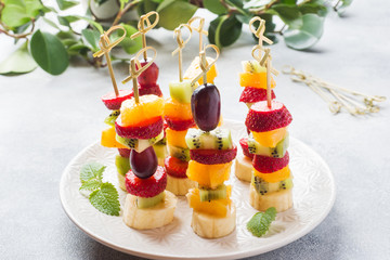 Fresh fruit on skewers. Concept buffet for a summer party.