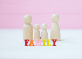 family and design concept - wooden family piece isolated on pink background 