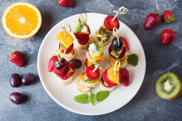 Fresh fruit on skewers. Concept buffet for a summer party. Copy space