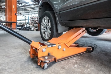 Naklejka premium Hydraulic car jack lift the new car for change the tyre