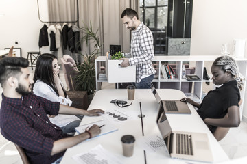 Business colleagues say goodbye to the dismissed employee at informal meeting in office