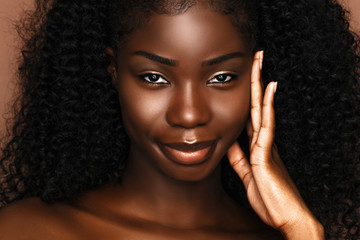 Beauty spa treatment concept.  African Skincare model portrait  with perfect dark skin and curly hair.