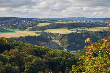 Fototapeta premium Aerial view to hills and agriculture fields of Rheinland-Pfalz state with river Rhein from tourist route on Hesse land