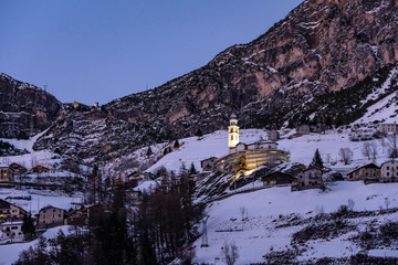 winter landscape (at sunset) of the high Valtellina, between the Italian central Alps, village of...