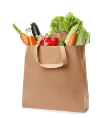 Fototapeta Paper bag with vegetables and bottle of juice on white background obraz