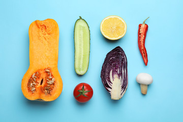 Flat lay composition with fresh ripe vegetables on color background