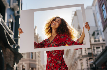 Pretty girl with a large empty frame