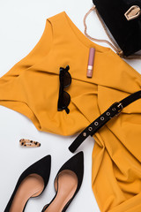 Beautiful mustard color dress, suede shoese and other feminine accessories.