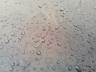 Rain umbrellas that are wet rain stains on the umbrella.   