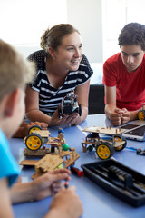 Students In After School Computer Coding Class Building And Learning To Program Robot Vehicle