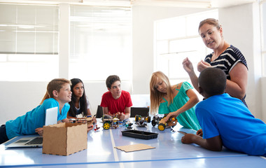 Students In After School Computer Coding Class Building And Learning To Program Robot Vehicle