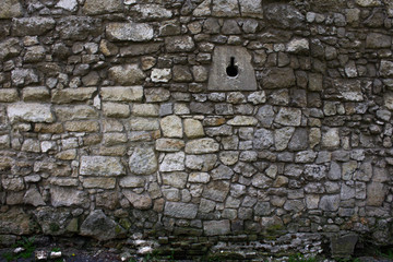 old stone brick wall with moss