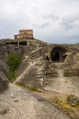 Cave city of Uplistsikhe with the basilica church in the background, in Georgia