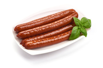 Grilled Pork Sausages with basil leaves, close-up, isolated on white background