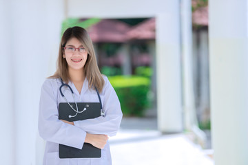 Fototapeta na wymiar Portrait of young asian doctor wear glasses in a hospital,Thailand people