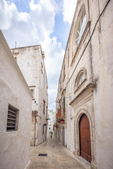 View of the old town of Martina Franca with a beautiful houses painted in white.