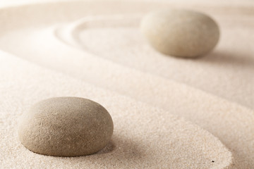 Yoga or spa wellness background of a Japanese zen garden. A round stone for concentration stands for harmony and purity..