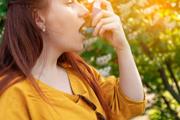 Allergy to flowering trees. Asthma and COPD disease concept. Young woman is trying to eliminate...