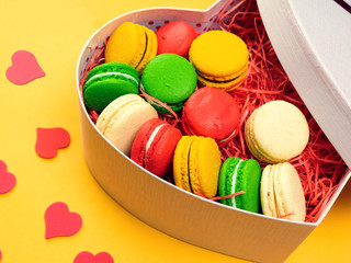 Macaroons in a gift box. Heart-shaped box. Copy space.