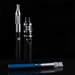 electronic cigarettes or vaping devices on black background