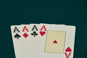 on the green table, stands out a set of four aces, at the bottom of the image leaving large space for inscriptions above