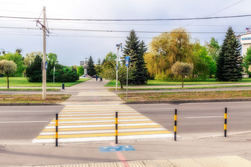 Naklejka premium Zebra crosswalk across the road in a big city.