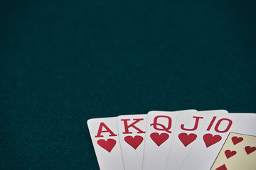 Poker Hands / Royal Flush 3. Five playing cards - the poker royal flush hand. Royal Flash,red card deck, poker royal flash on cards and poker chips on green casino table. success in gambling.