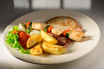 Mixed Grilled meat and vegetables decorated on a plate ready to be served in restaurant