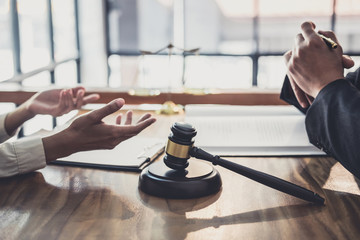 Consultation and conference of professional businesswoman and Male lawyers working and discussion having at law firm in office. Concepts of law, Judge gavel with scales of justice