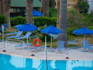 Tropica Empty pool Lifebuoy chairs and umbrellas