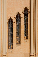Three windows offset in a row in the wall of a church in Sevilla, Andalusia, Spain.