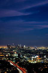 Fototapeta na wymiar LOS ANGELES, CALIFORNIA - FEB 13: Night view of smoggy Los Angeles downtown. LA is well known for its Hollywood film district.