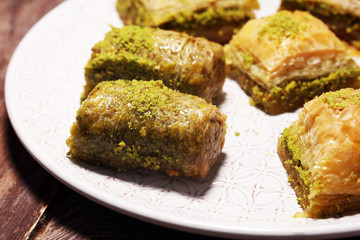 Middle eastern or arabic dishes. Turkish Dessert Baklava with pistachio on dishes