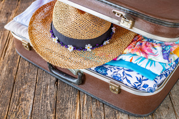 Suitcase preparation for a summer holiday , Retro , vintage and old luggage   
