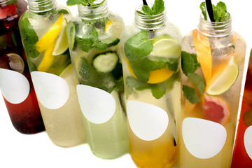 Summer lemonade bottles with lemon, strawberry. orange, cucumber, pomegranate, grapefruit .mint beverage cocktail isolated on white background