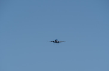 Big passenger airplane flying in blue sky