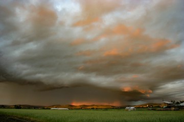 Colorful storm over the countryside in Romania at sunset