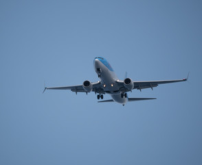 Fototapeta na wymiar Big passenger airplane flying in blue sky