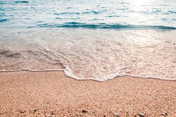Soft wave of blue ocean on sandy beach