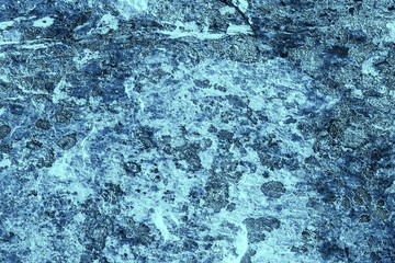 Vintage blue background. Rough painted wall of sapphire color. Imperfect plane of blue colored. Uneven old decorative toned backdrop of cyan tint. Texture of sapphirine hue. Ornamental stony surface.