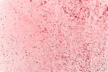 Vintage pink background. Rough painted wall of fiesta color. Imperfect plane of rosy colored. Uneven old decorative toned backdrop of rouge tint. Texture of pink hue. Ornamental stony surface.