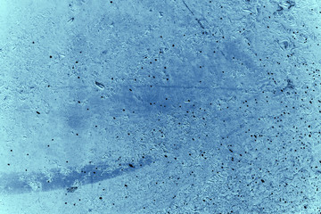 Vintage blue background. Rough painted wall of sapphire color. Imperfect plane of blue colored. Uneven old decorative toned backdrop of cyan tint. Texture of sapphirine hue. Ornamental stony surface.