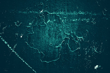 Vintage azure background. Rough painted wall of turquoise color. Imperfect plane of cyan colored. Uneven old decorative toned backdrop of aqzure tint. Texture of teal hue. Ornamental stony surface.