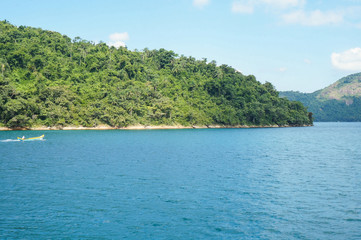  Man in a canoe at islands in Paraty, Rio de Janeiro, Brazil