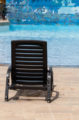 Fototapeta premium pool chair by the pool on a sunny day