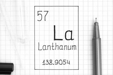 Handwriting chemical element Lanthanum La with black pen, test tube and pipette.